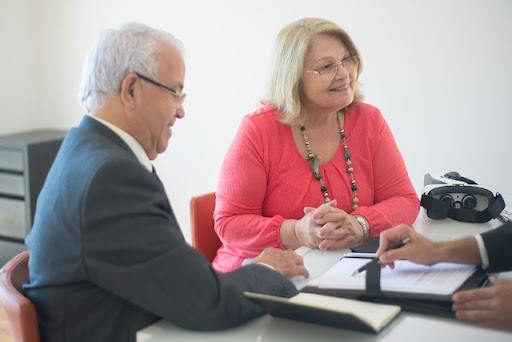 A senior couple discussing mortgage options with a financial advisor
